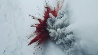 Red and gray powder explosion colliding in mid-air against white background, creating dramatic cloud formation with dynamic motion and contrasting colors.