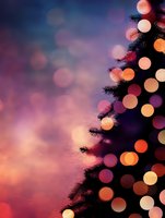Festive Christmas tree silhouette with glowing bokeh lights against purple sunset sky background, creating magical holiday atmosphere.