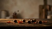 Scattered roasted coffee beans with red chili peppers on rustic wooden surface, suitable for food and beverage marketing, café branding, and culinary content.