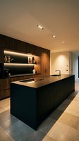 Modern luxury kitchen featuring sleek black island with wood cabinetry, ambient lighting, and minimalist design for contemporary home interiors and architectural publications.