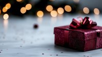 Elegant burgundy gift box with shiny bow on marble surface against soft bokeh lights, perfect for holiday or celebration designs.
