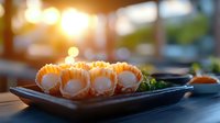 Fresh salmon sushi rolls with cream cheese served on black ceramic plate against warm sunset lighting, creating atmospheric dining ambiance for restaurant menu.