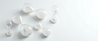 Clear glass marbles scattered on white background for modern minimalist design projects and creative applications.
