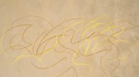 Graffiti-style lettering in gold and tan tones on textured beige wall surface. Urban street art design element suitable for backgrounds, overlays, and creative projects.
