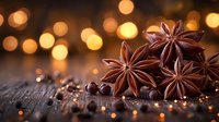 Star anise pods and black peppercorns on rustic wooden surface with warm golden bokeh lights creating cozy festive atmosphere for seasonal cooking.