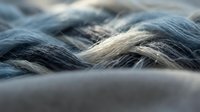 Close-up of twisted rope fibers showing texture and depth, suitable for industrial, nautical, and construction-related projects.