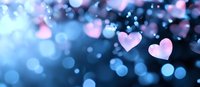 Pink heart shapes floating on dreamy blue bokeh background with glowing light effects and soft focus blur, romantic atmosphere for Valentine's Day designs.
