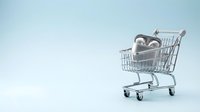 Shopping cart filled with car tires on light blue background, representing automotive retail, spare parts commerce, and vehicle maintenance shopping needs.