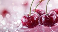 Fresh ripe cherries with water droplets on glossy surface against soft pink bokeh background, creating appetizing fruit composition.