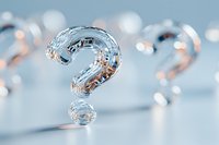 Crystal clear glass question mark on light blue background with soft bokeh effect creates conceptual composition about uncertainty and curiosity.