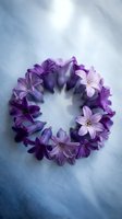 Purple hyacinth flowers arranged in a circular wreath on a soft blue fabric background, spring floral flat lay for cards and decor.