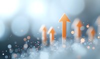 Orange upward arrows rising against blurred blue bokeh background with glowing particles, representing growth, success and positive business trends.