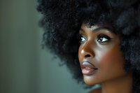 Beautiful African American woman with natural afro hairstyle and flawless makeup in artistic beauty portrait perfect for cosmetic advertising and fashion campaigns.