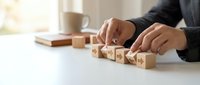 Professional arranging wooden blocks with star ratings on white desk for customer feedback and business evaluation concept.