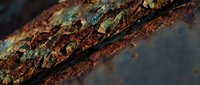 Rusty metal surface with peeling paint showing corrosion and weathering effects creating textured industrial background for design projects.