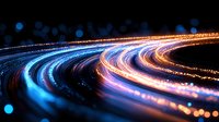 Glowing curved light trails in blue, orange and pink colors against dark background create dynamic motion effect for technology and innovation concepts.