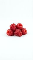 Fresh red raspberries isolated on white background for healthy eating and organic food concepts.
