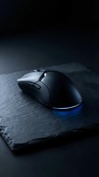 Black gaming mouse with blue LED lighting on dark slate surface, ideal for gaming, technology, and computer equipment marketing.