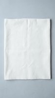 White cotton fabric textile material flat lay on gray background for sewing crafts fashion design projects and creative applications.