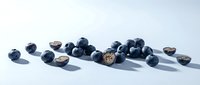 Fresh blueberries scattered on white surface with natural shadows, isolated for food photography, culinary design, and healthy eating content.
