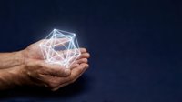 Hands holding glowing geometric network structure with connected nodes and lines representing digital connectivity and data visualization concept.