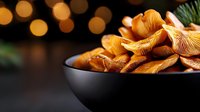 Fresh wild chanterelle mushrooms in black ceramic bowl on dark background with golden bokeh lights, close up view for restaurant menu and food blogs.