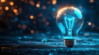 Glowing light bulb with blue energy and golden bokeh lights on dark background symbolizing innovation and creative ideas for business concepts.