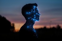Male silhouette profile with glowing blue constellation effect against sunset sky, representing artificial intelligence, technology and human consciousness.
