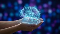 Glowing digital brain hologram floating above open human hands against colorful bokeh background representing artificial intelligence and neuroscience.