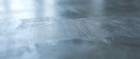 Close-up macro view of weathered wood grain texture with natural patterns and soft blue-gray tones for backgrounds and design projects.