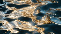 Mesmerizing golden and blue water surface with rippling reflections creating abstract patterns. Liquid texture with metallic sheen for luxury backgrounds.
