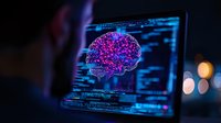 Digital brain visualization on laptop screen with glowing purple and blue neural network, programming code interface in dark workspace with bokeh lights.