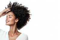 Young African American woman with natural curly hair smiling with closed eyes, wearing white top against white background, expressing joy and confidence.