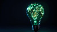 Glowing light bulb with illuminated world map pattern made of green sparkles and particles on dark background, symbolizing global innovation and connectivity.