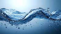 Dynamic water wave with splashing droplets and bubbles creating flowing motion against blue background, macro photography capturing liquid movement and transparency.