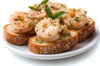 Grilled shrimp bruschetta with fresh herbs and spices on crusty bread slices served on white plate, close up view of appetizing seafood starter.