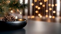 Pine cones in black ceramic bowl against blurred holiday lights and evergreen branches create cozy winter atmosphere with warm bokeh background.