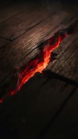 Glowing red hot crack in dark wooden surface with dramatic lighting creating atmospheric mood for creative projects and design concepts.