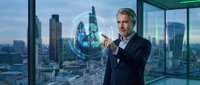 Mature Caucasian businessman in suit touching holographic Earth globe interface in modern office with city skyline view representing global business technology.