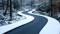 Winding road curves through snowy winter forest landscape with fresh white snow covering ground and trees creating dramatic S-shaped path through woodland.