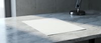 Blank white paper sheet on marble desk with lamp in modern office interior, mockup for design presentation.