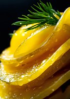 Fresh yellow bell pepper slices with water droplets and dill garnish on dark background, macro photography showing vibrant colors and textures.