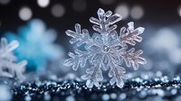 Crystal clear snowflake with intricate geometric patterns on sparkling surface with bokeh lights creating magical winter atmosphere for holiday designs.
