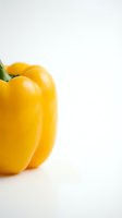 Fresh yellow bell pepper isolated on white background, ideal for food and culinary design projects.