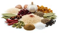 Aromatic spices and herbs collection with rice, garlic, dried chilies, bay leaves, cardamom, star anise, cranberries and seasonings on white background.