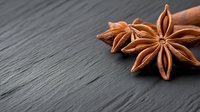 Star anise spice on dark wooden background with copy space for culinary and cooking projects.