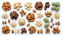 Assorted nuts and seeds including almonds, cashews, peanuts, hazelnuts, and pistachios arranged on white background for food, nutrition, and healthy eating designs.