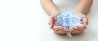 Hands holding glowing digital city hologram with futuristic buildings and technology interface on white background for business innovation concepts.