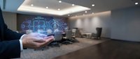 Businessman hand presenting digital network icons in modern office conference room with holographic technology display for business presentations.