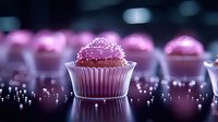 Pink frosted chocolate cupcake with sprinkles in paper wrapper on reflective dark surface with bokeh lights creating magical atmosphere. Sweet dessert macro photography.